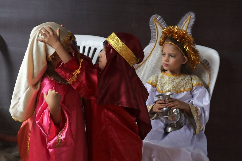 Children get ready to take part in a re-enactment of the Via Crucis (Way of the Cross) during Good Friday celebrations in Lima, Peru.