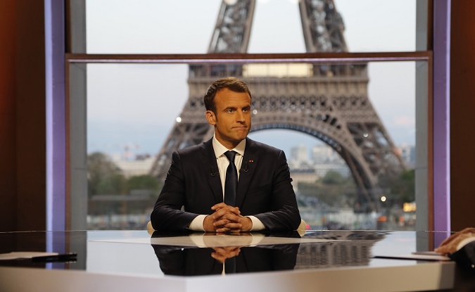 French President Emmanuel Macron poses on the TV set before an interview with French journalists at the Theatre National de Chaillot in Paris, France, April 15, 2018.