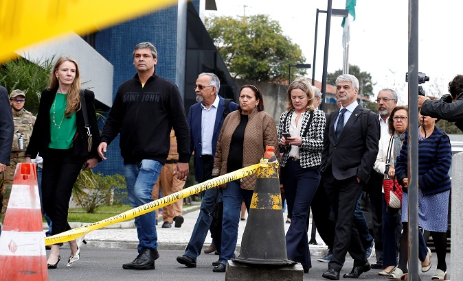 Senators leave the Federal Police headquarters, where Brazilian President Luiz Inacio Lula da Silva is imprisoned, after trying to visit him, in Curitiba, Brazil April 17, 2018.