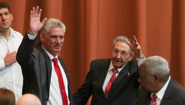 Newly elected Cuban President Miguel Diaz-Canel (L) and former Cuban President Raul Castro wave during the National Assembly in Havana, Cuba, April 19, 2018.
