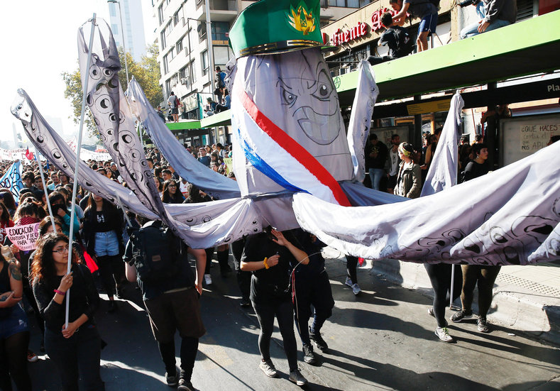 A group of protesters carrying a puppet depicting President Sebastian Piñera as an octopus.