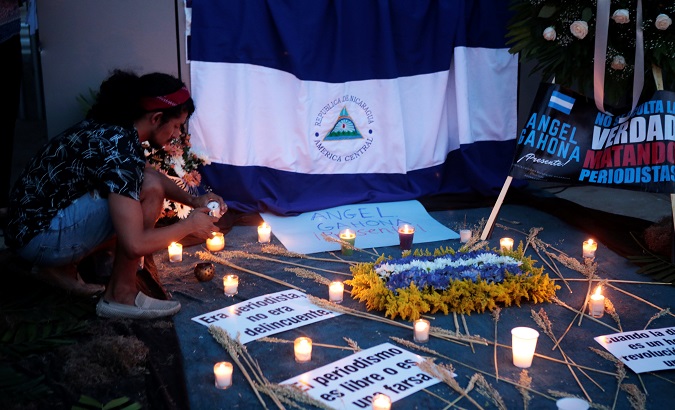 Nicaraguans hold a candlelit vigil for the state-media journalist killed during last week's violent social-reform protests.