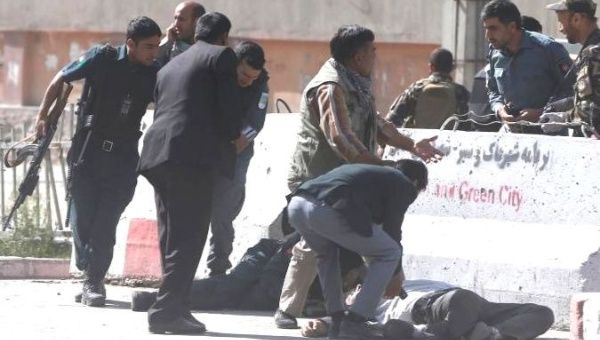 Policemen help Afghan journalists, victims of a second blast, in Kabul, Afghanistan April 30, 2018. 