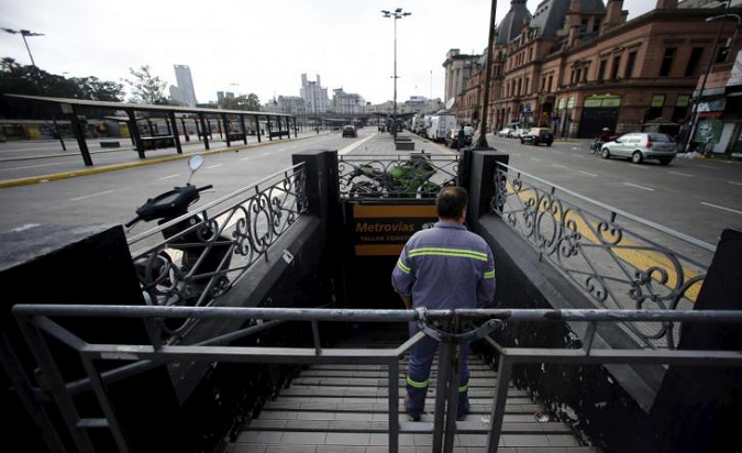 A subway worker stands on the stairs of a closed metro access during a one-day nationwide strike in Buenos Aires March 31, 2015.