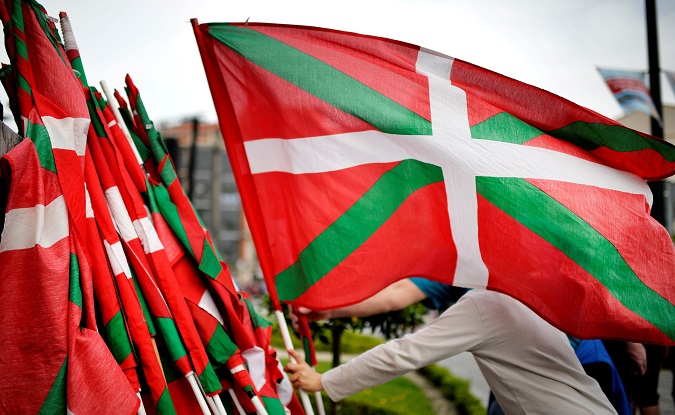 A man lays down a Basque flag at the end of a rally in support of ETA prisoners in Bilbao, April 21.