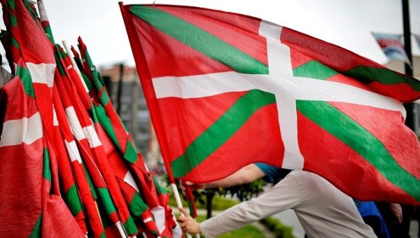 A man lays down a Basque flag at the end of a rally in support of ETA prisoners in Bilbao, April 21.