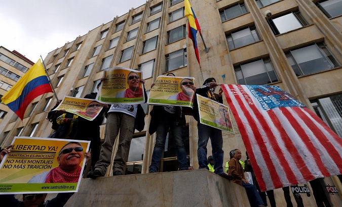 Supporters of Seuxis Paucias Hernandez, better known by his alias Jesus Santrich, hold posters asking for his freedom during a rally commemorating May Day in Bogota, Colombia May 1, 2018.