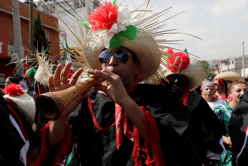 A Mexican wearing period costume takes part in a re-enactment of the Battle of Puebla, along the streets in the Penon de los Banos neighbourhood of Mexico City.