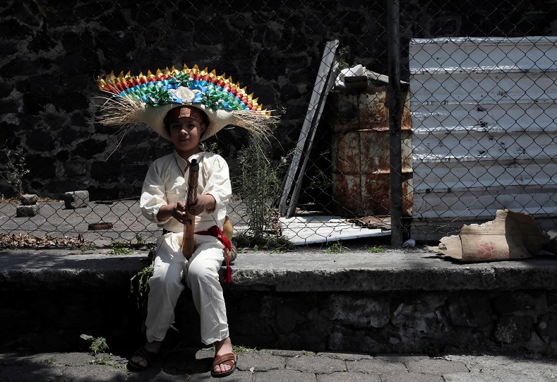 A Mexican boy wearing period costume waits before taking part in the re-enactment.