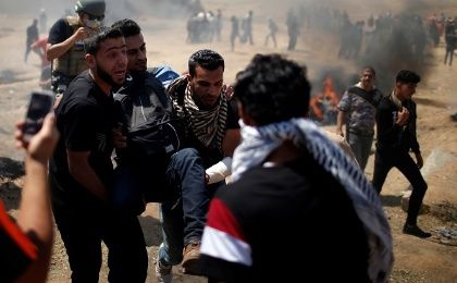 A wounded Palestinian is evacuated during a protest against U.S. embassy move to Jerusalem and ahead of the 70th anniversary of Nakba, at the Israel-Gaza border.