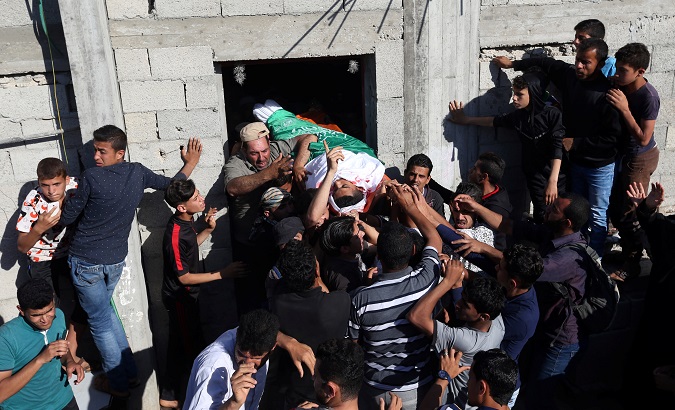 Mourners carry the body of a Palestinian, who was killed during a protest at the Israel-Gaza border, during his funeral in Khan Younis in the southern Gaza Strip.