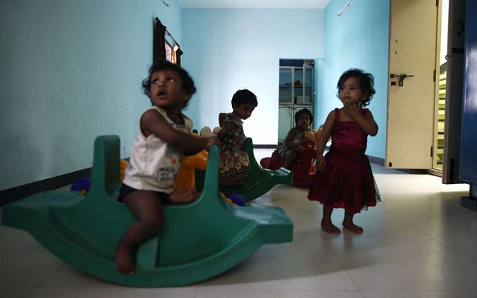 Baby girls play inside the Life Line Trust orphanage in Salem in the southern Indian state of Tamil Nadu June 20, 2013.