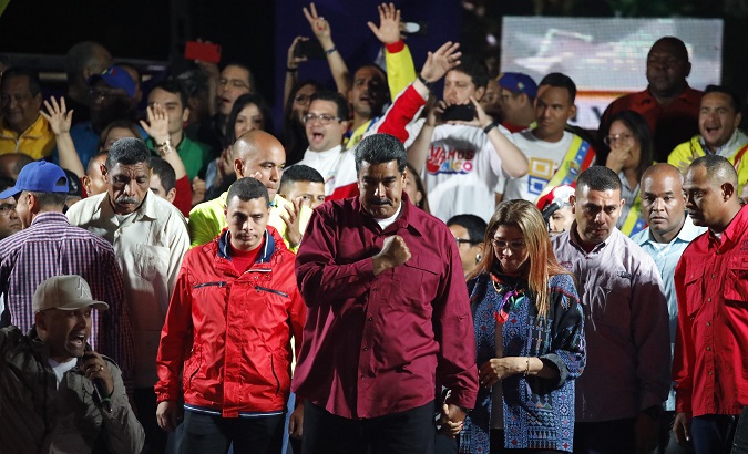 Venezuela's President Nicolas Maduro stands with supporters during a gathering after the results of the election were released, outside of the Miraflores Palace in Caracas.