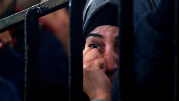 A Palestinian woman in the southern Gaza Strip waits for a travel permit to cross into Egypt through the Rafah border crossing after it was opened by Egyptian authorities for humanitarian cases.