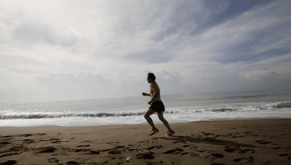 A man runs along the beach as hurricane Matthew approaches in Kingston, Jamaica, October 2, 2016.