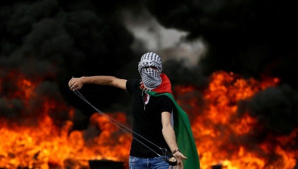 A Palestinian holds a sling during a protest marking the 70th anniversary of Nakba, near the Jewish settlement of Beit El, near Ramallah, in the occupied West Bank.