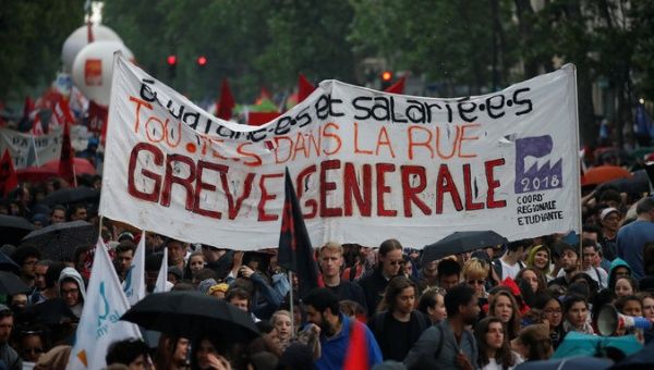 French civil servants and students carry labour union flags and banners as they march in protest during a national day of strikes by public sector workers.