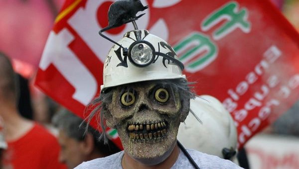 A French sanitation and sewer worker marches in protest during a national day of strikes by public sector workers in Lyon, France