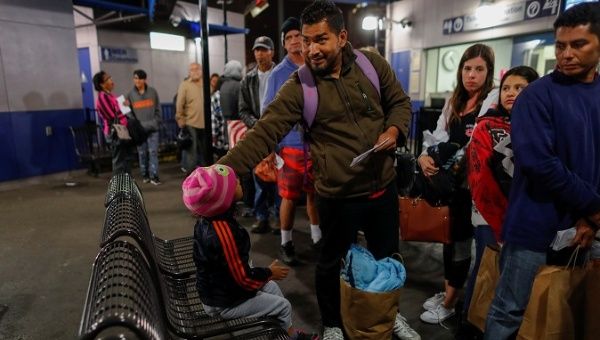Immigration caravan travelers prepare to board a Greyhound bus for Phoenix following their release into the United States from U.S. Customs officials in San Diego, California. May 7, 2018