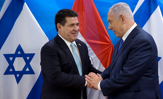 Paraguayan President Horacio Cartes shakes hands with Israeli Prime Minister Benjamin Netanyahu during a meeting at the Prime Minister's office in Jerusalem.