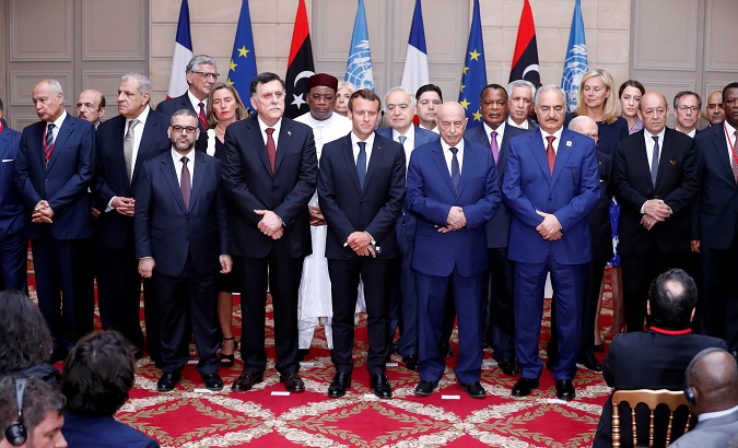 The participants of the International Conference on Libya listen to an agreement between various parties regarding election this year, at the Elysee Palace in Paris.