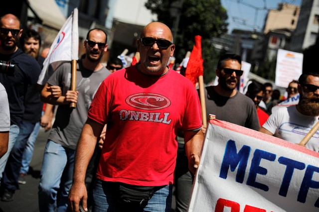 Members of the Communist-affiliated PAME shout slogans during a demonstration marking a 24-hour general strike against planned austerity measures in Athens, Greece. 