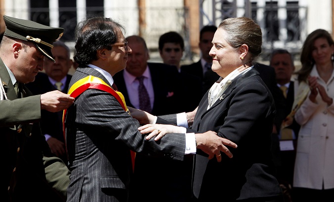 Then mayor-elect Gustavo Petro getting the sash from acting mayor Clara Lopez during the swearing in ceremony in Bogota.