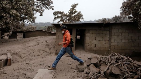 A man walks through an area affected by eruption from Fuego volcano in the community of San Miguel Los Lotes in Escuintla, Guatemala June 4, 2018.