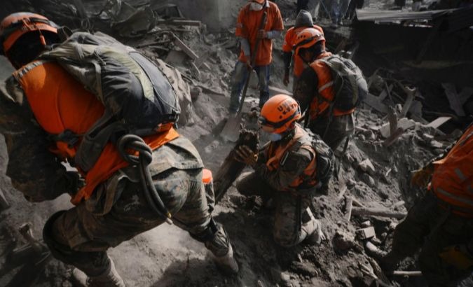 Soldiers search for remains at an area affected by the eruption of El Fuego volcano in Guatemala.