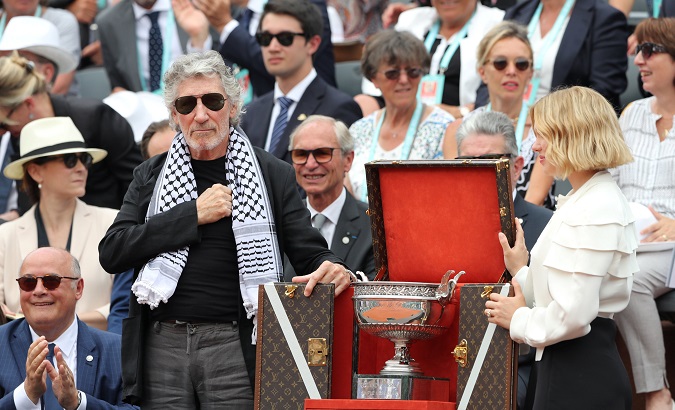 Singer Roger Waters with the trophy before the final between Spain's Rafael Nadal and Austria's Dominic Thiem