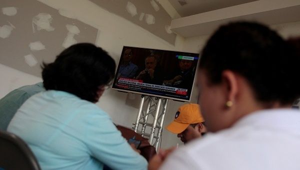Journalists follow a live transmission of talks between representatives of Nicaragua's government and local civic groups.