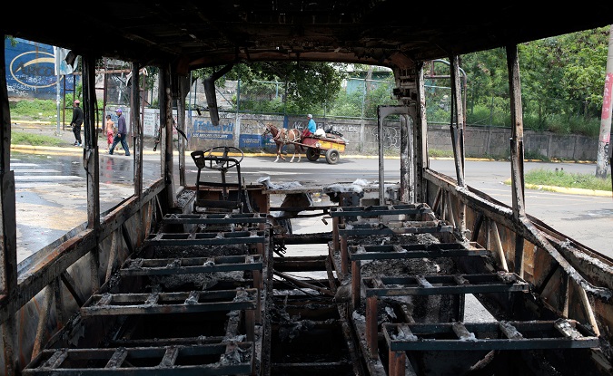 A burned bus is seen during a protest against Nicaragua's President Daniel Ortega.