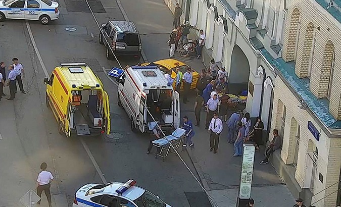 Police and emergency workers at the scene where a taxi hit a group of pedestrians in Moscow, Russia.