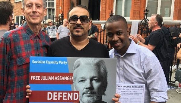 Human rights campaigner Peter Tatchell (L) with demonstrators outside London's Ecuadorean Embassy.