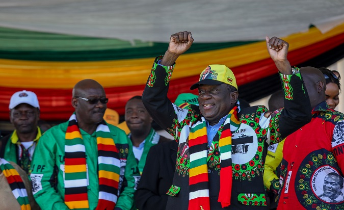 Zimbabwe's President Emmerson Mnangagwa greets supporters before an explosion at an election rally in Bulawayo, June 23, 2018.
