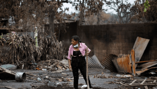 who lost 50 members of her family during the eruption of the Fuego volcano, rests holding a shovel while searching for her family in San Miguel Los Lotes in Escuintla, Guatemala, June 15, 2018.
