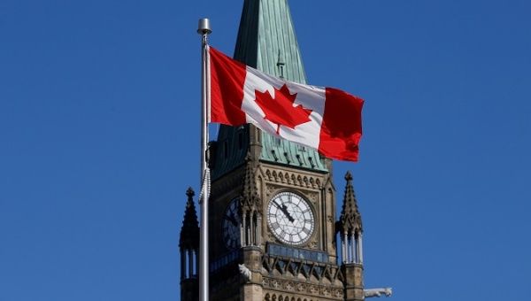 Canada's  flag flies in front of the Peace Tower on Parliament Hill in Ottawa, Ontario, Canada, March 22, 2017
