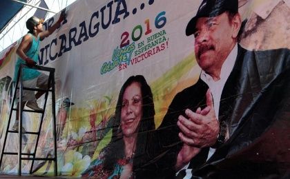 A man hoists a banner in support of Nicaragua's President Daniel Ortega.