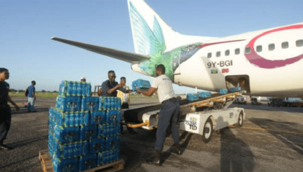 Members of Trinidad and Tobago's Air Guard load water on a relief flight organized by Caribbean airlines, for people on Sin Maarten (Saint Martin) island following Hurricane Irma, at the international airport in Piarco, Trinidad and Tobago. September 16, 2017. 