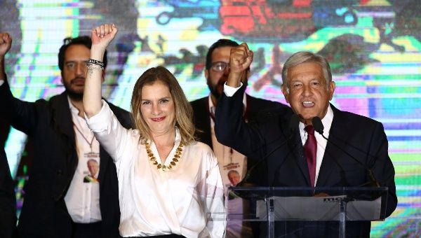 Presidential candidate Andres Manuel Lopez Obrador gestures with his wife Beatriz Gutierrez Muller and family as he addresses supporters after polls closed in the presidential election in Mexico City, Mexico Sunday. 