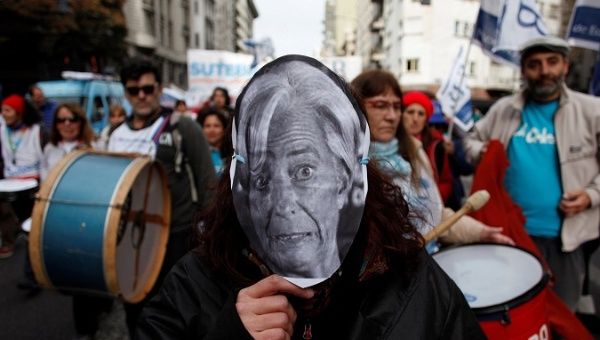 A teacher wears a Christine Lagarde mask during a protest at the Ministry of Education in Buenos Aires to demand better pay.