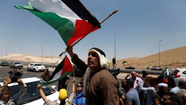 Palestinians attend a protest against Israel's plans to demolish the Bedouin village of Khan al-Ahmar, in the occupied West Bank July 6, 2018. 