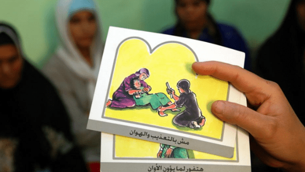  A counselor holds up cards used to educate women about female genital mutilation (FGM).