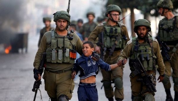 Israeli forces datain a Palestinian child in the occupied West Bank. 