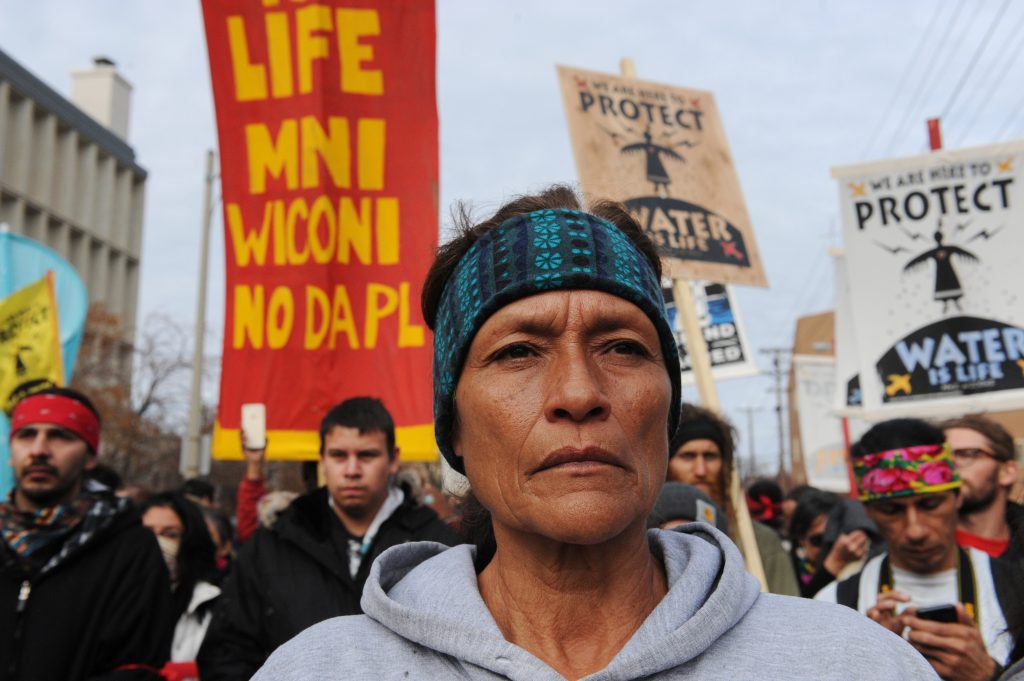People march during a protest in Bismarck against plans to pass the Dakota Access pipeline under Lake Oahe and near the Standing Rock Indian Reservation, North Dakota