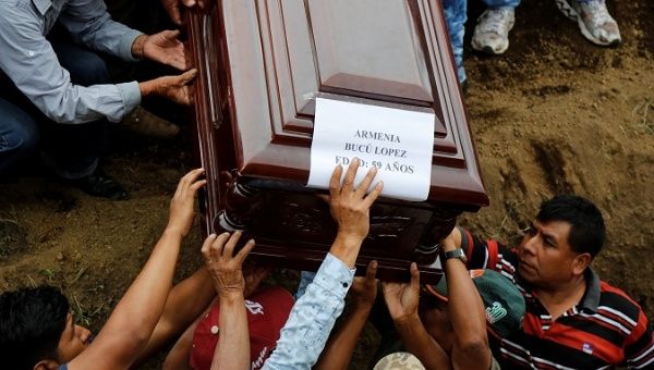 Relatives and friends attend the funeral of victims of the Fuego volcano eruption at a cemetery in Alotenango, Guatemala.