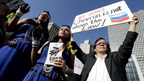 Indigenous women and international allies demand corporate accountability outside a New York City Court. 