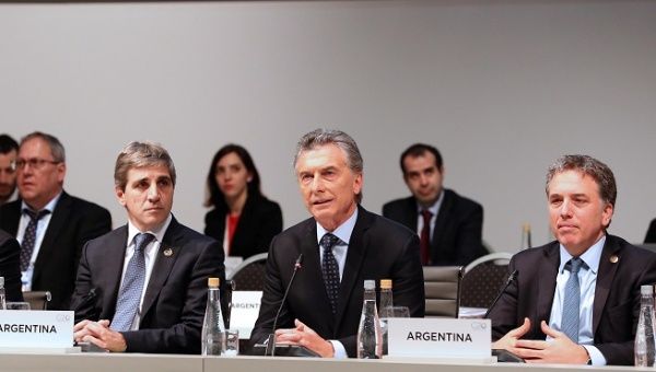 Argentine President Mauricio Macri speaks alongside Treasury Minister Nicolas Dujovne (R) and Central Bank President Luis Caputo at the G20 Meeting of Finance Ministers in Buenos Aires, Argentina, July 22, 2018