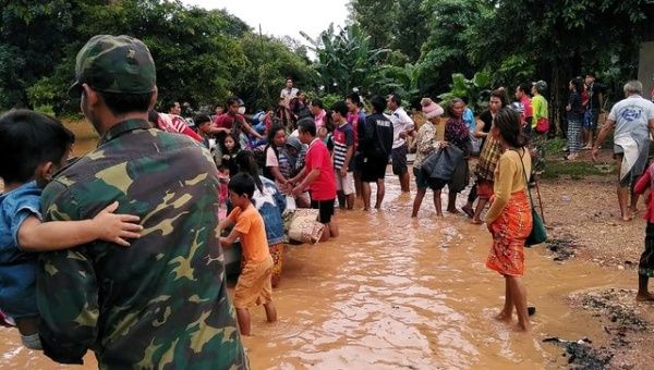 Villagers carry their belonging as they evacuate after the Xepian-Xe Nam Noy hydropower dam collapsed in Attapeu province, Laos.