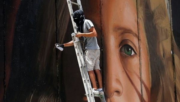 The 13-foot mural is the creation of Italian street artist Agostino Chirwin, who has a reputation for painting activists.